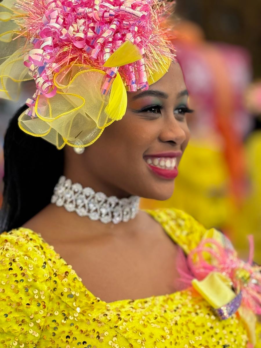 Amoni at the Dunkin Thanksgiving Day Parade in yellow sequin costume
